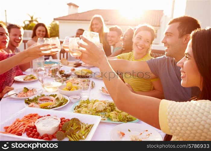 Group Of Young People Enjoying Outdoor Summer Meal