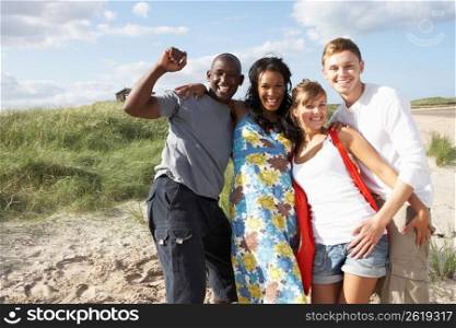 Group Of Young People Having Fun On Beach Together