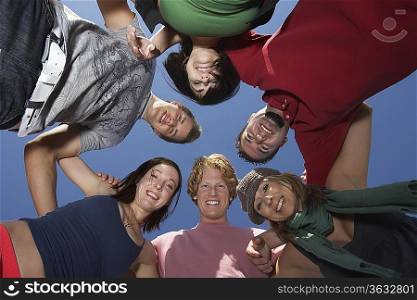 Group of young people in circle, view from below