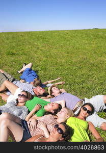 group of young people lying in field