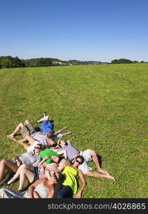 group of young people lying in field
