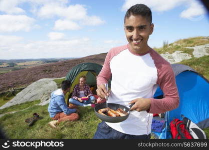 Group Of Young People On Camping Trip In Countryside