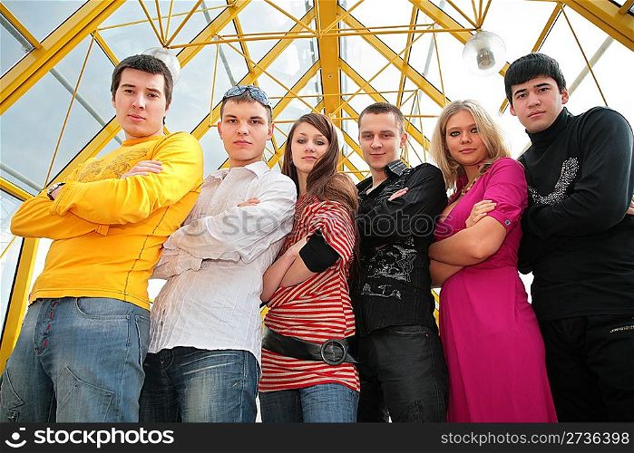 group of young people on footbridge view from below
