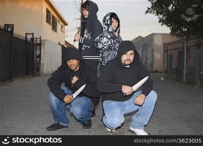 Group of young people posing with knives