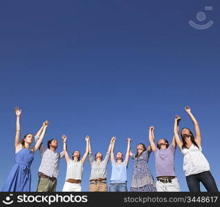 group of young people raising arms