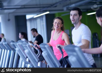 group of young people running on treadmills in modern sport gym