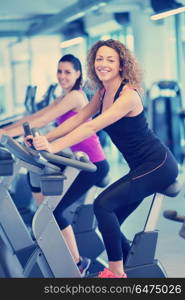 group of young people running on treadmills in modern sport gym. Group of people running on treadmills