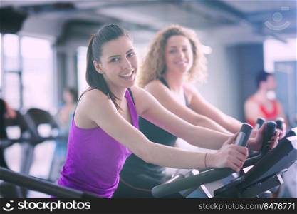 group of young people running on treadmills in modern sport gym. Group of people running on treadmills