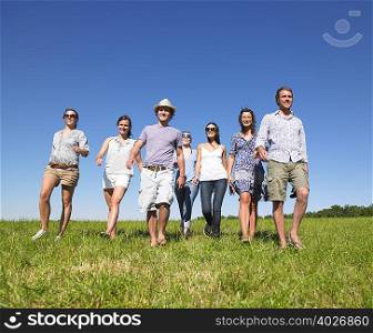 group of young people walking in field