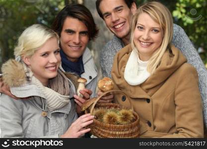 group of young people with a basket of chestnuts and mushrooms
