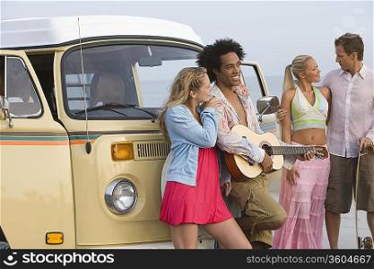 Group of young people with camper van