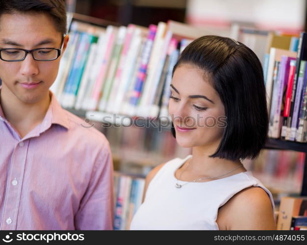 Group of young students at the library. Group of young students working together at the library