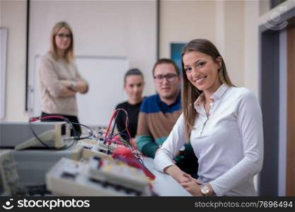 Group of young students doing technical vocational practice with teacher in the electronic classroom, Education and technology concept