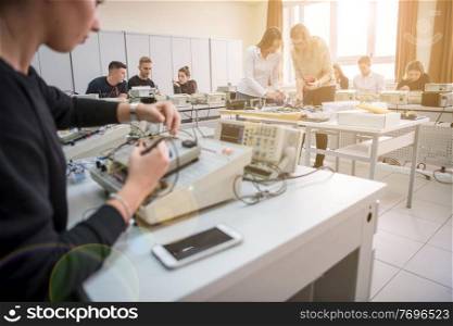 Group of young students doing technical vocational practice with teacher in the electronic classroom, Education and technology concept