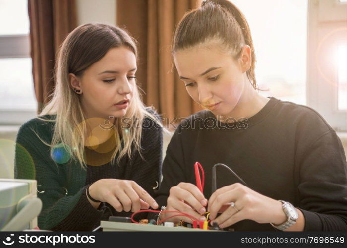 Group of young students doing technical vocational practice with teacher in the electronic classroom, Education and technology concept