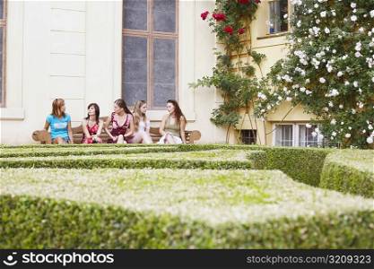 Group of young women sitting on a bench