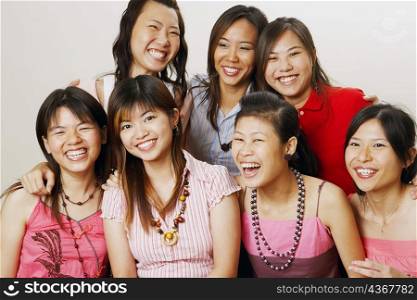 Group of young women sitting together and looking cheerful