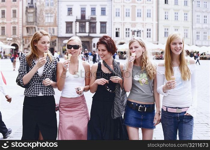 Group of young women walking with ice-cream cones