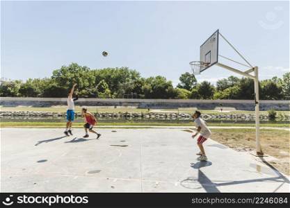 group player playing basketball outdoors court