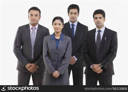 Group portrait of confident business people standing against white background