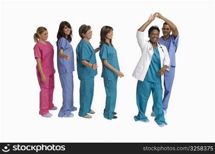 Group portrait of doctors and nurses dancing