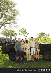Group portrait of four tourists and safari guide