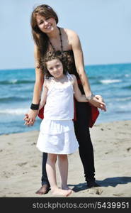 group portrait of happy childrens with young female teacher on beach