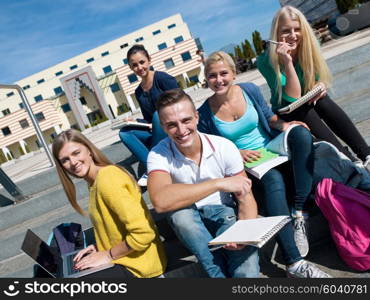 Group portrait of happy students outside sitting on steps have fun