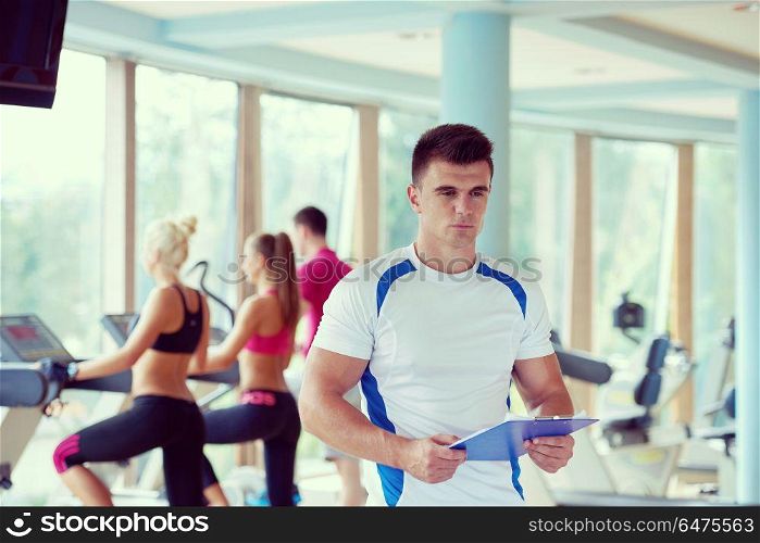 group portrait of healthy and fit young people in fitness gym. people group in fitness gym