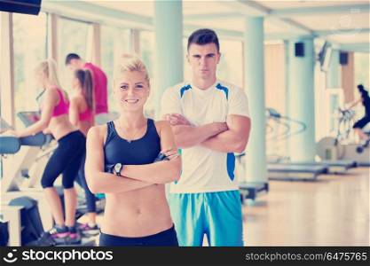 group portrait of healthy and fit young people in fitness gym. people group in fitness gym