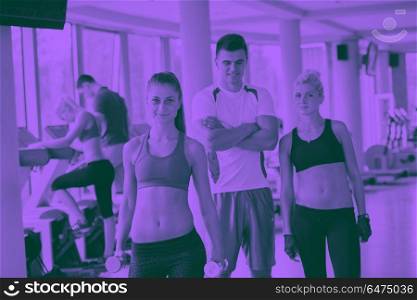 group portrait of healthy and fit young people in fitness gym duo tone. people group in fitness gym