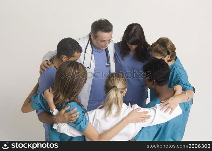 Group portrait of nurses and doctors in huddle