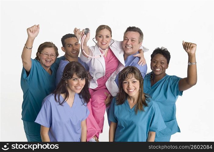 Group portrait of nurses carrying doctor