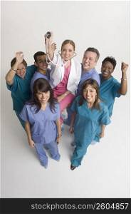 Group portrait of nurses carrying doctor