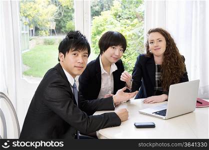 Group portrait of three businesspeople