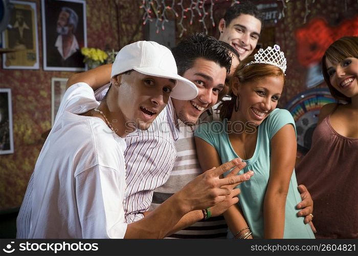 Group portrait of young adults at local hang out, night