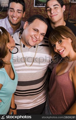 Group portrait of young adults at local hang out, night