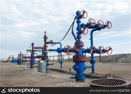 Group production wellheads and conduit with valves. Oil and gas industry. . Oilfield. Concept oil and gas industry.