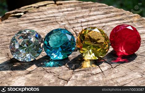 Group round cut diamond at color red yellow blue and clear on wood background