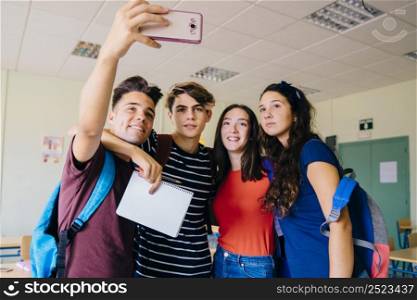 group schoolkids taking selfie classroom