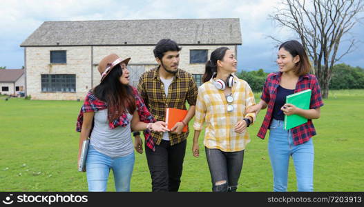 Group Students Smile and have fun It also helps to share ideas in the work and project. And also review the book before the exam outdoor in the garden.