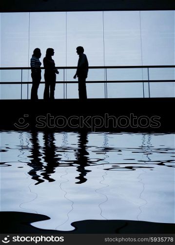 group talking in the building, with water reflection