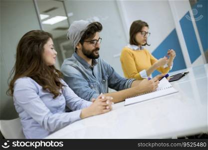 Group young coworkers together discussing creative project during work process