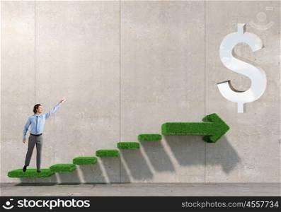 Growing success and progress. Businessman reaching hand to touch stone growing arrow graph