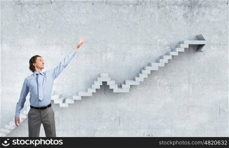 Growing success and progress. Businessman reaching hand to touch stone growing arrow graph