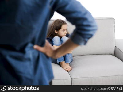 Grown up rebuking a little child for bad behavior