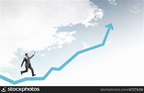 Growth and progress in business. Young businessman running on increasing arrow graph