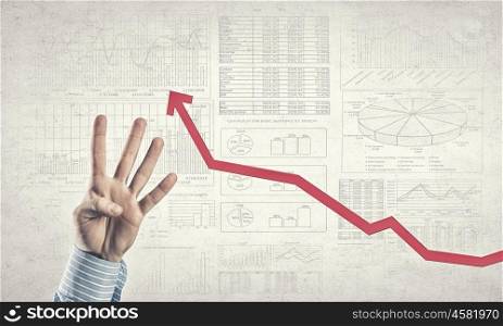 Growth concept. Businessman hand showing gesture and red growing graph