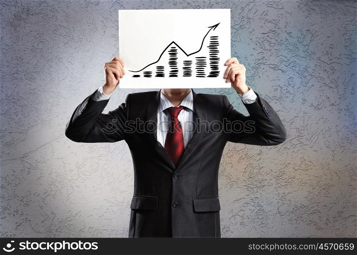 Growth concept. Businessman hiding his face behind paper with drawing