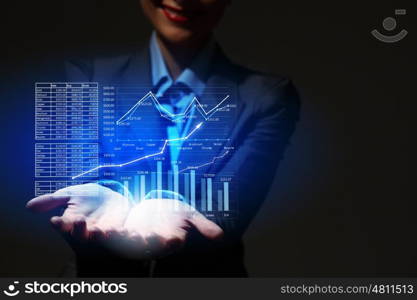 Growth concept. Close up of businesswoman hand presenting digital charts